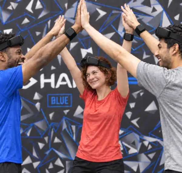 Teammates celebrating with a high five after a HADO match