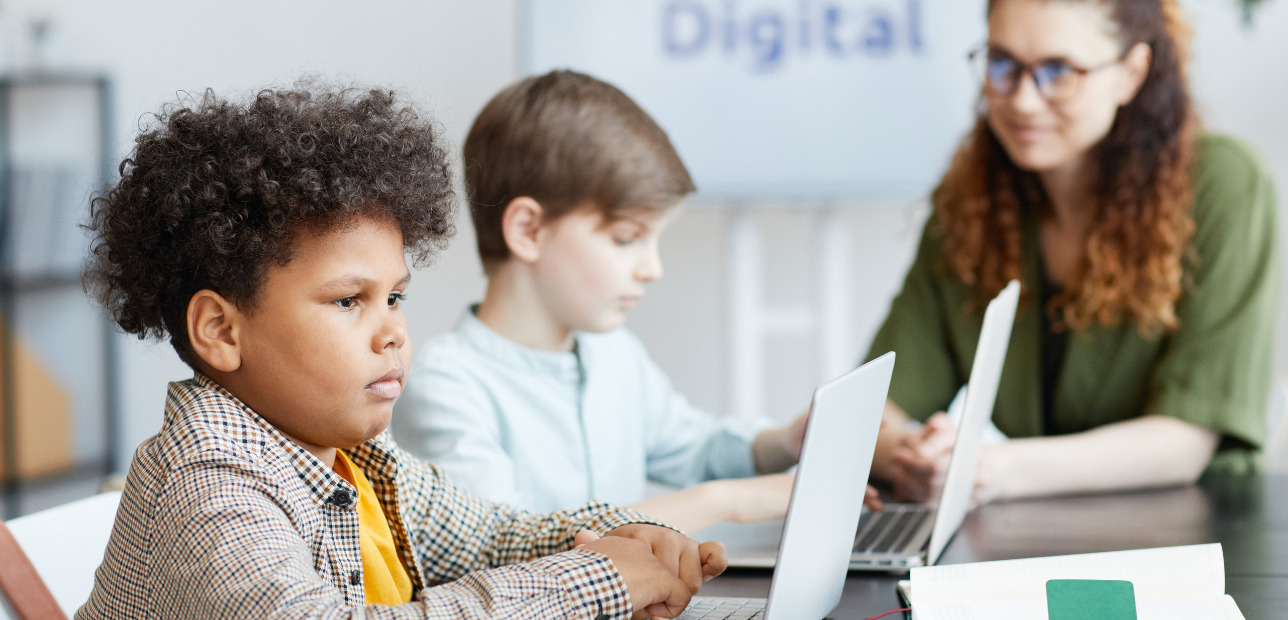 nstructor supervising children in an esports learning environment