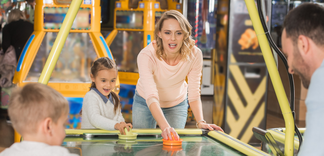 Families enjoying attractions at a family entertainment center