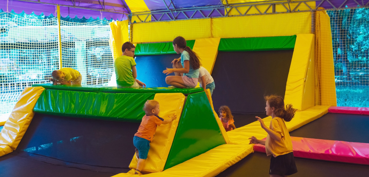 Families enjoying active play inside a modern trampoline park